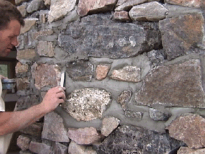 Pointing or grouting slipform stonemasonry work.